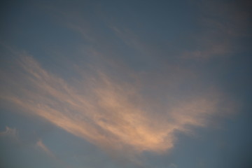 The sun  rays illuminate the sky with clouds. We see the background of the sky of natural color as in the picture. This image of a beautiful sky and white clouds pleases all people.