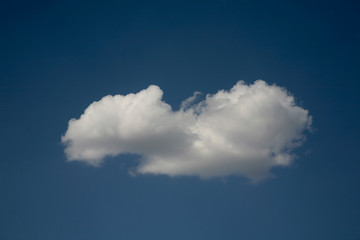 Beautiful clouds float across the blue sky. This background is illuminated by the natural light of heaven. Beautiful clouds and the sky are illuminated by bright light.