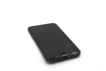 smart phone with broken screen, Broken screen cell phone on gray background. Smartphone Insurance and Mobile phone warranty concept. top view.
