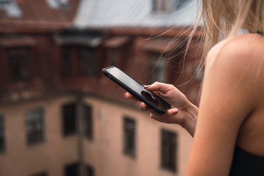Woman's hand holding smartphone, close-up
