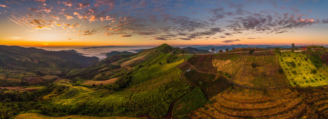 Naklejka premium Beautiful panorama air view of mountain rang with hightway road at sunrise time.
