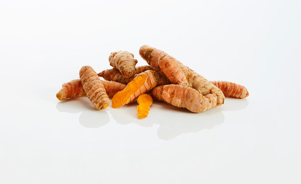 Curcuma roots on white ground