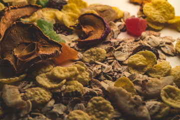 Muesli breakfast mix with candied oatmeal and cornflakes, raisins and flax seeds on a white background creatively. Food concept. Natural food.