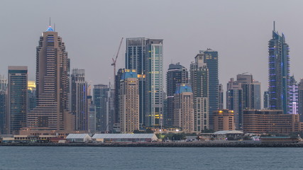 Fototapeta na wymiar Dubai Marina skyline day to night timelapse as seen from Palm Jumeirah in Dubai, UAE.