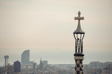 Fototapeta na wymiar BARCELONA, SPAIN - NOVEMBER 4, 2018: Top view of Park Guell in the background if morning mist and grey sky
