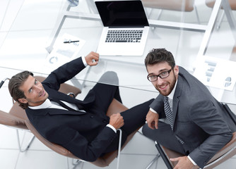 smiling business colleagues sitting at Desk