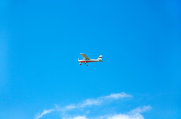 Fototapeta na wymiar Light aircraft on blue sky as background