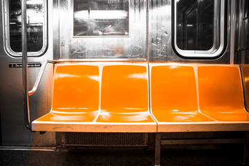 View inside New York City subway train car with vintage orange color seats