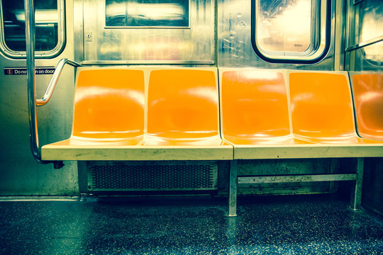 View inside New York City subway train car with vintage orange color seats © littleny