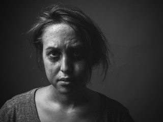 Young woman with smeared make up. Black and white. Low key