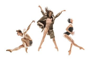 Beautiful slim young modern jazz contemporary style ballet dancers in silhouette wearing beige long...