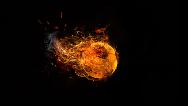 Close-up soccer ball in fire on dark background. The football, sport, goal, game, speed concept
