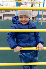 Obraz premium Portrait of a boy on the stairs in the park