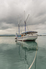 Obraz premium Sailing Boat, Sailboat at Mactan Strait, Mactan, Cebu, Lapu Lapu, a Tranquil scene with a calm sea, seascape, a nice Yacht tied with a rope and reflection in the water