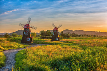 Fototapeta premium The sun rises in early morning windmill at Sora Ecological Wetland Park in Seoul, South Korea