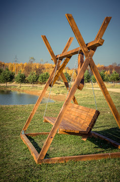 Wooden swing on the lawn