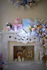 Decorative fireplace decorated with garlands. Christmas decoration of the house.Comfort