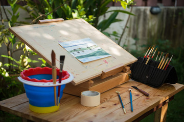 Artist painting watercolor in the garden