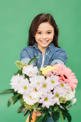selective focus of smiling child with flower bouquet looking at camera isolated on green