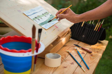 Artist painting watercolor in the garden