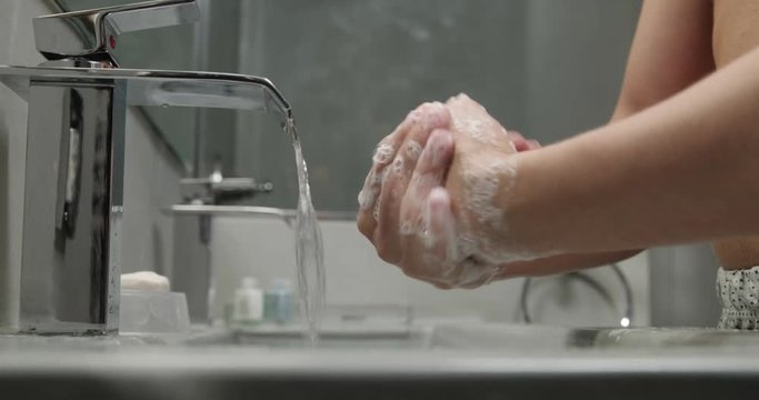 Slow Motion Closeup of Man Washing His Hands With Soap