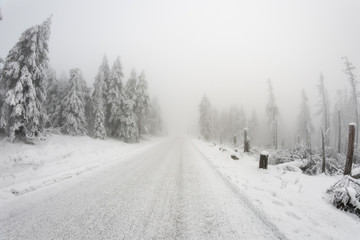 Fototapeta premium Snow covered road uphill a mountain
