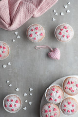 Sugar-sprinkled muffins with pink and white fondant icing hearts