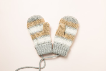 Winter knitted gloves isolated on pink background