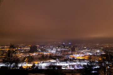 Fototapeta na wymiar Overlooking the city center of Oslo Norway during the winter all covered with fresh snow during the evening time