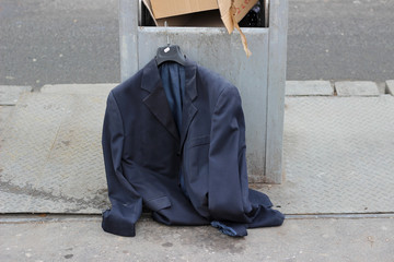 Suit jacket hanger left trash garbage bin reuse symbol