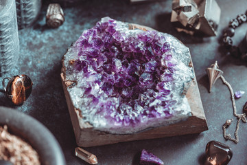 Amethyst Druze on a witch's altar for a magical ceremony among crystals and black candles.