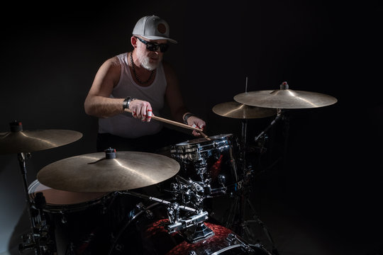 The old drummer on a dark background