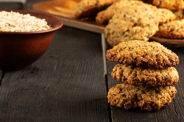 Oatmeal cookies with milk on tray on rustic wooden table