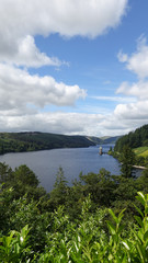 Fototapeta na wymiar Lake Vyrnwy, Wales, with blue sky and cloud in the summer, and tower stood in the water