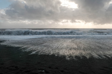 Wave of sea in black beach