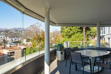 Lounge terrace composed of chairs and table overlooking the city of Lugano in Switzerland