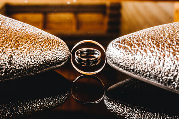 Closeup wedding rings with bridesmaid shoes