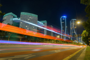 Fototapeta na wymiar abstract image of blur motion of cars on the city road at night，Modern urban architecture in hangzhou, China