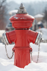 Red fire hydrant on the street. Fireplug in the snow