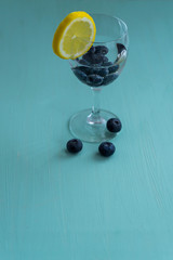 glass of detox water with lemon and blueberry