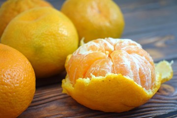 Ripe useful tangerines on wooden background.