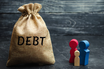 A bag of money with the word Debt and the family. The concept of debt for property. Mortgage. Real...