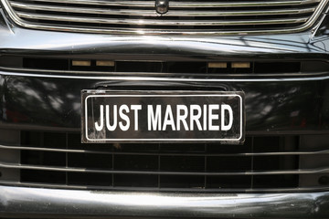 Fototapeta na wymiar Just married sign in luxury wedding car