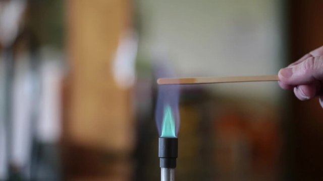 Sodium solution burning on a wooden splint in a bunsen burner flame.