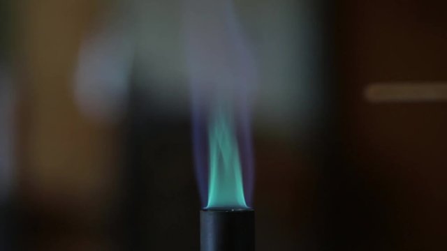 Sodium solution burning on a wooden splint in a bunsen burner flame.