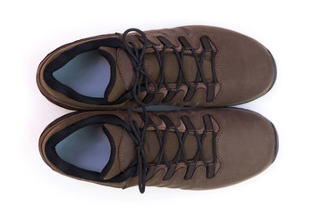 Top view of a pair of unbranded brown trekking shoes isolated on white background