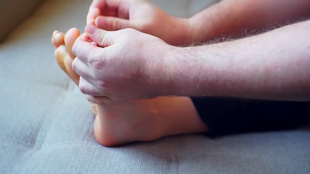 men's hands massaging children's feet. close-up