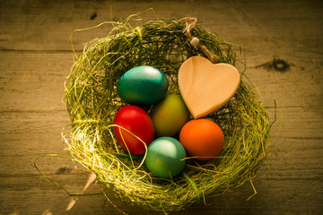 Frohe Ostern, Osternest mit bunten Ostereiern und Herz - Happy Easter, Easter nest with colorful...