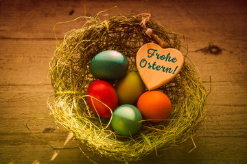 Frohe Ostern, Osternest mit bunten Ostereiern und Herz - Happy Easter, Easter nest with colorful Easter eggs and heart