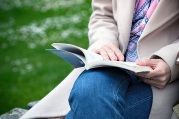 girl at the park reading a book
